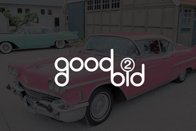 Pink and blue sedan in a parking lot with the words 'Good 2 Bid' written in white.